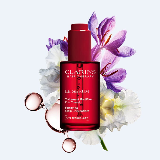 Clarins scalp serum for hair longevity and density, enriched with saffron and organic plant extracts for scalp health.