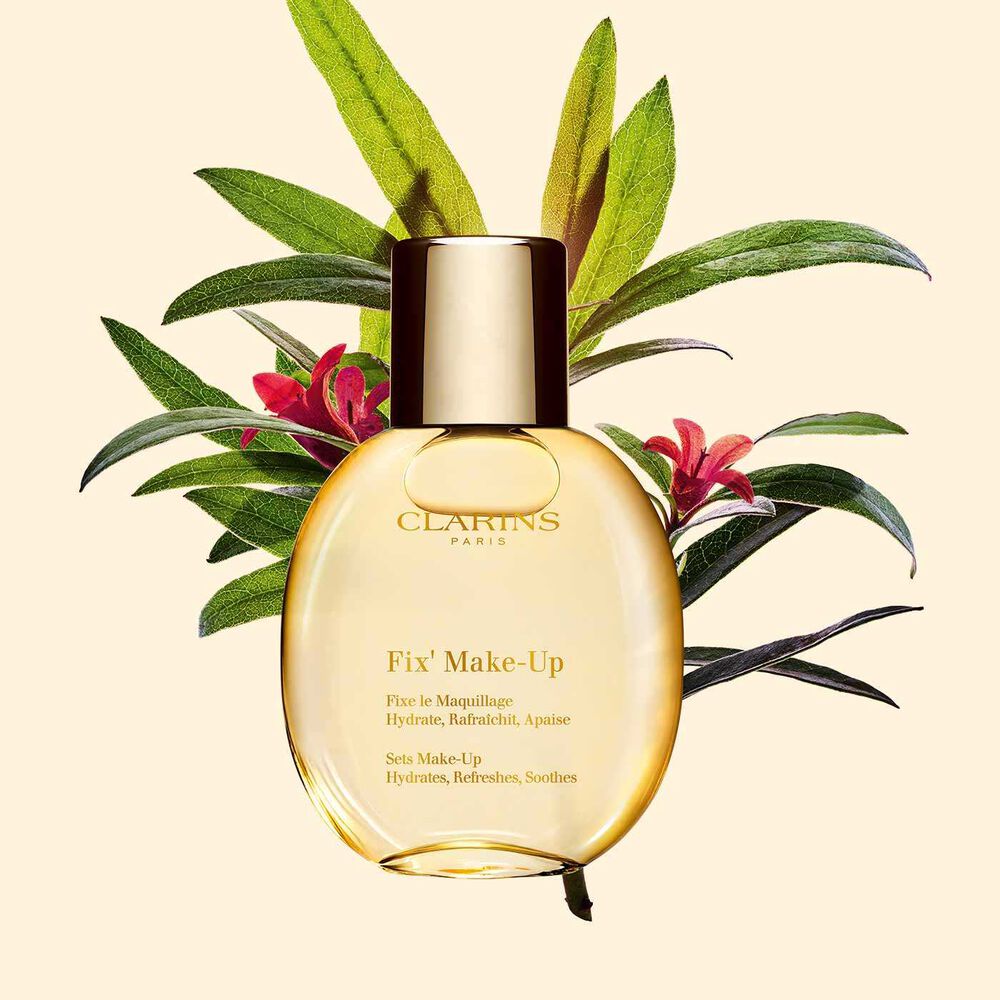 Packshot of Clarins Make-up Fixer Spray Fix' Make Up positioned beside a bouquet of alpienroses on a light yellow background