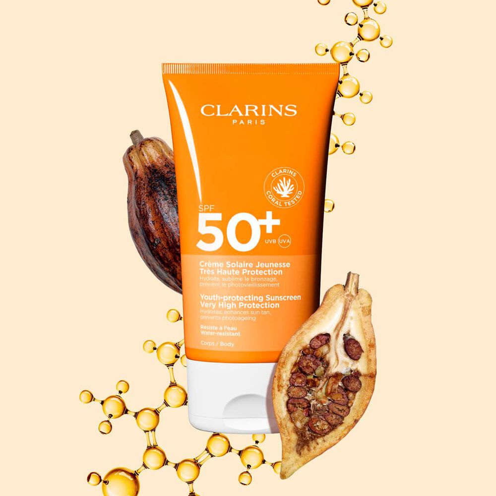 Photo of Clarins Youth-Protecting Sunscreen High Protection SPF 50 for the body, among collagen molecules and cocoa beans.