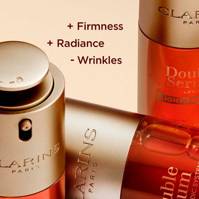 Close-up of Clarins Double Serum Light Texture bottles, highlighting enhanced firmness, radiance, and reduced wrinkles.