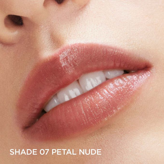 Close-up of a woman's lip wearing Clarins Fairy Blossoms Lip Oil Balm in Petal Nude, to illustrate its smoothing benefits.