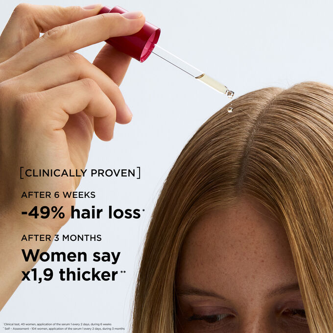 Applying hair loss serum directly to the scalp to improve hair longevity and stimulate density for a thicker appearance