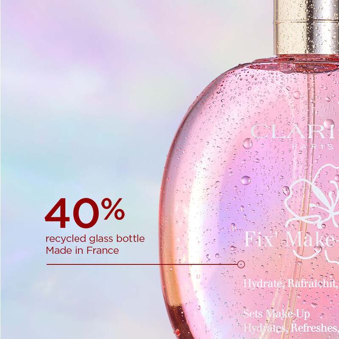 Focus on the pinky round glass bottle of Clarins Fix' make up to emphasise its 40% recycled glass bottle made in France.