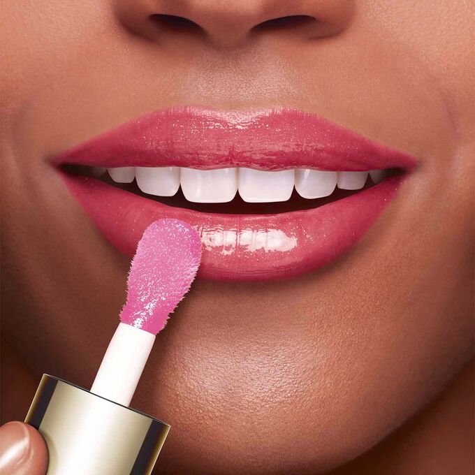 Close-up of a woman's lips showing the effect of Clarins Lip Comfort Oil.