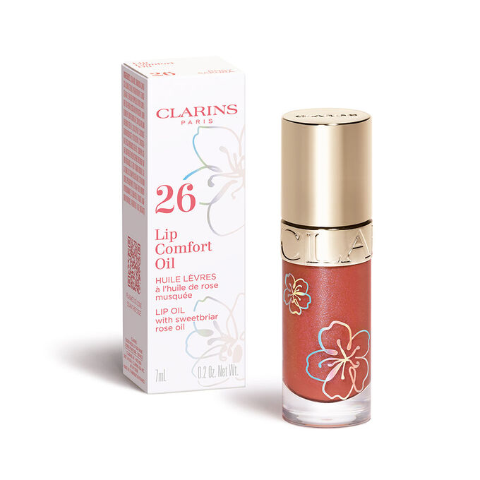 Packshot of the Clarins Lip Comfort Oil in the shade Rosy Sakura from the Fairy Blossoms range and its secondary packaging.