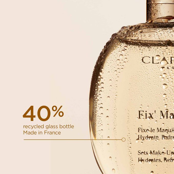 Close-up of the Makeup Fixer Spray glass bottle, illustrating that it is made from 40% recycled glass and produced in France